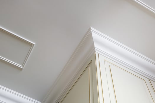 Detail of corner ceiling cornice with intricate crown molding. photo