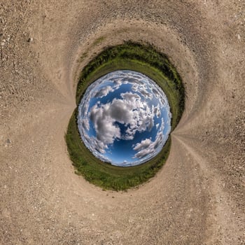 blue sphere little planet inside gravel road or field background. photo