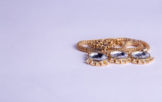 gold necklace on a white photo