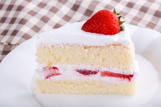 Strawberry cake on table photo