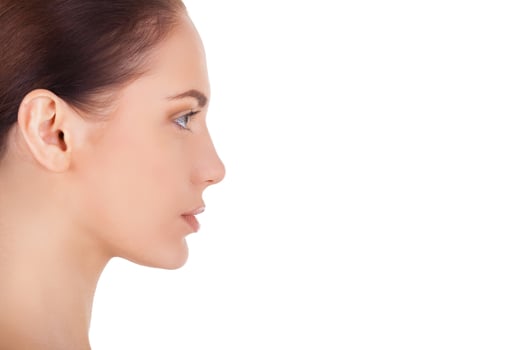 Beautiful and natural. Side view of beautiful young woman looking away while isolated on white photo