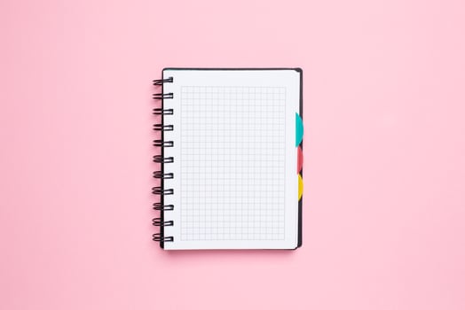 Notebook in a cage on a pink background photo