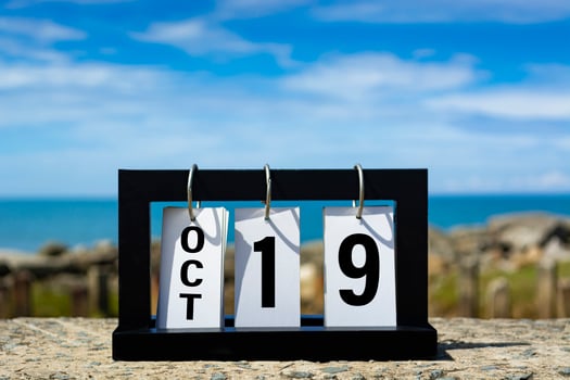Oct 19 calendar date text on wooden frame with blurred background of ocean. photo