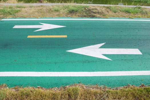 green road with white arrow. photo