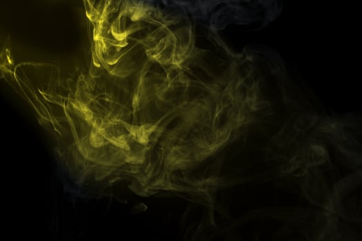 Abstract  golden powder or smoke isolated on black background photo
