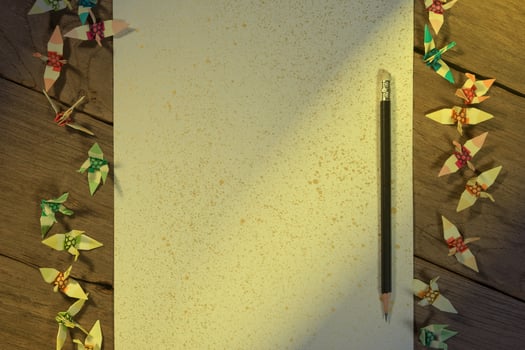 A sheet of paper with a pencil on wooden office desk photo