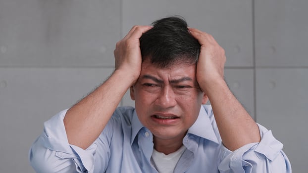 Asian old man with migraine headache. Man feel stressed and worried about health problems. photo