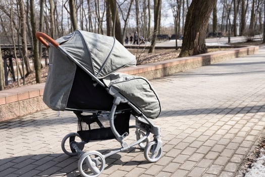 Baby stroller with baby in the park outdoors. photo
