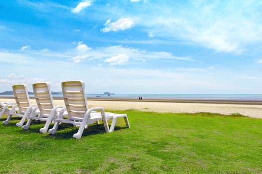 White beach chair on tropical beach with blue sky photo