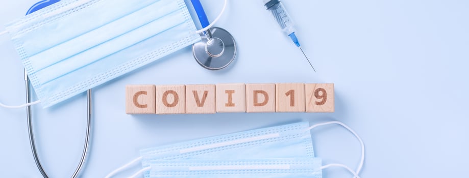 COVID-19 word wooden cube with mask, medical equipment, world disease pandemic infection and prevention concept, top view, flat lay, overhead design photo
