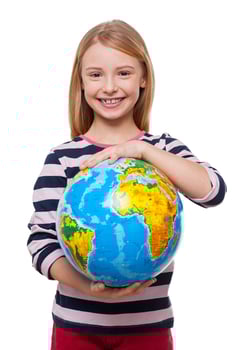 World in my hands Cheerful little girl holding a globe and smiling while standing isolated on white photo