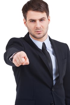 I choose you Confident young man in formalwear pointing you while standing isolated on white photo