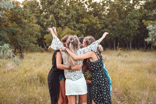 Girls stand in a circle embracing each other photo