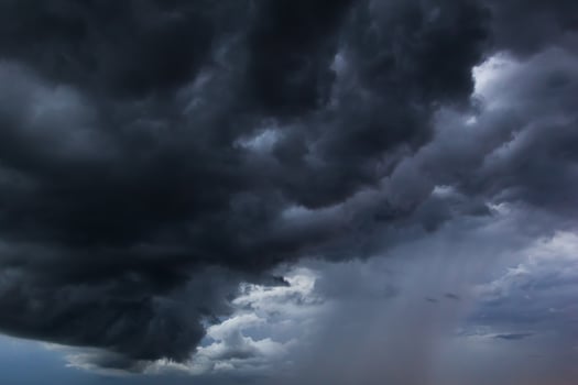 The dark sky had clouds gathered to the left and a strong storm before it rained. photo
