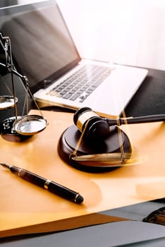 Business and lawyers discussing contract papers with brass scale on desk in office. Law, legal services, advice, justice and law concept picture with film grain effect photo