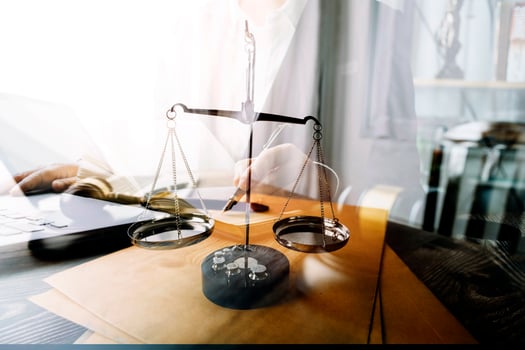 Business and lawyers discussing contract papers with brass scale on desk in office. Law, legal services, advice, justice and law concept picture with film grain effect photo