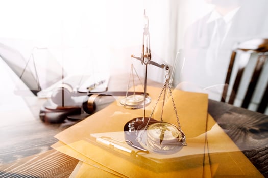 Business and lawyers discussing contract papers with brass scale on desk in office. Law, legal services, advice, justice and law concept picture with film grain effect photo