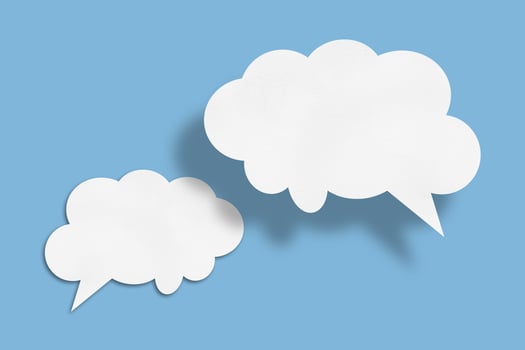 white cloud paper speech bubble shape against blue background photo