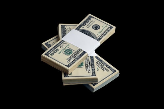 Bundle of US dollar bills isolated on black. Pack of american money with high resolution on perfect black background photo