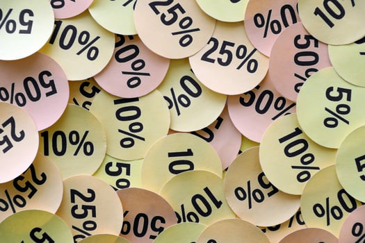 Large amount of stickers with yellow percentage values for black friday or cyber monday sale. Abstract image of discount prices photo