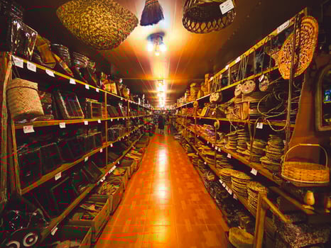 Bandar Anzali, Iran, 2022 - Tourist woman explore Handmade products baskets accessories shop in Bandar Anzali photo