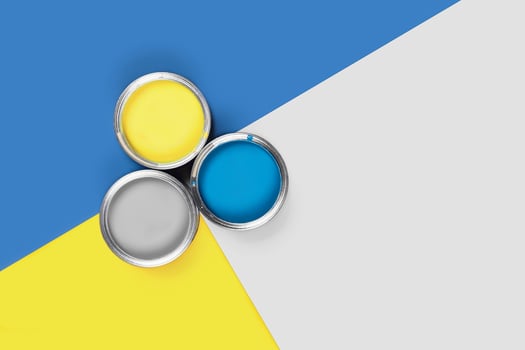 Three-colored background with paint jars. photo