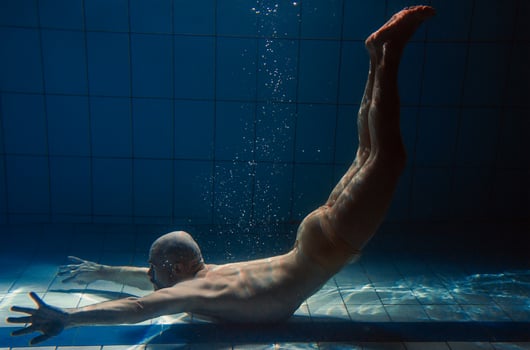athletic sport man underwater in the swimming pool. Sports, yoga, free diving concept photo