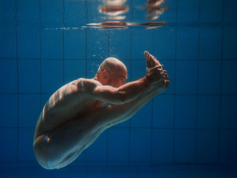 athletic sport man underwater in the swimming pool. Sports, yoga, free diving concept photo
