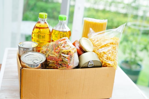 Foodstuffs in donation box for volunteer. photo