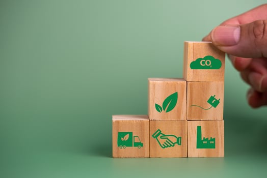 Hand holding wood cube block icon co2 carbon credit and eco energy green technology on green background. photo