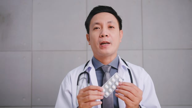 Asian man doctor talking with patient via video call conference. photo