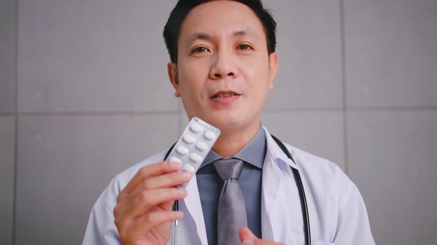 Asian man doctor talking with patient via video call conference. photo