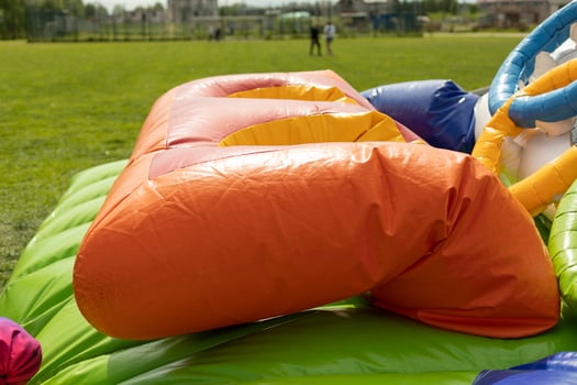 Deflating inflatable trampoline. Amusement park gathering. Details of playground. photo