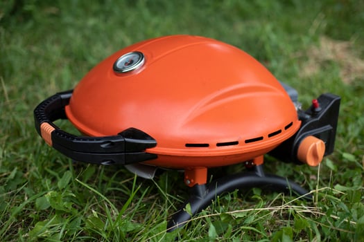 Orange grill. Gas grill for frying food. Picnic details. photo