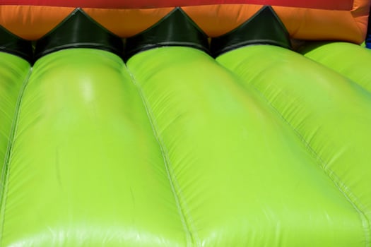 Inflatable trampoline. Amusement park. Green rubber. photo
