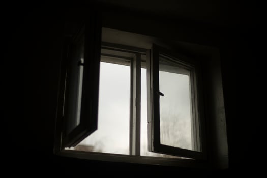Window is in dark. Open window in building. photo