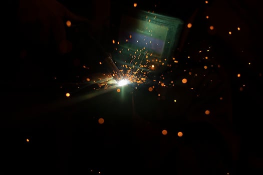 Welding work. Sparks from welding metal. Production details. photo