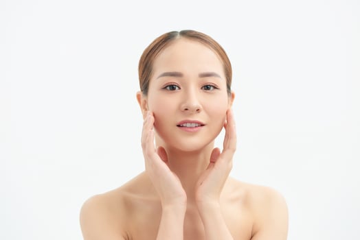 Young woman touching her face isolated on white background photo