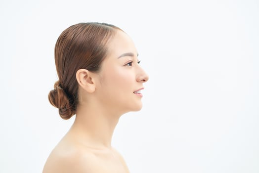Beauty portrait of a young attractive half naked woman with perfect skin looking away isolated over white background photo