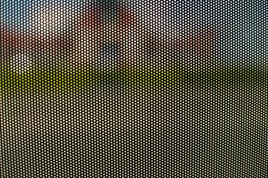Mesh texture on glass. Shooting window. Small cage. photo