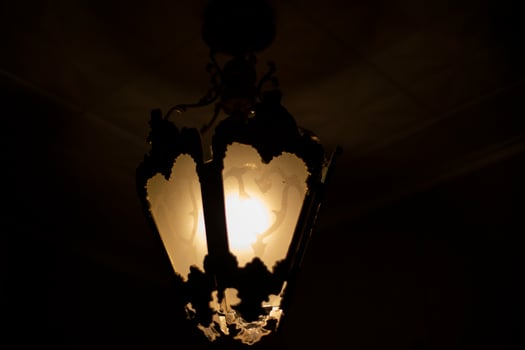 Lamp in dark. Light source. Old chandelier. photo