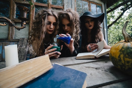 Three vintage witches perform magic ritual photo