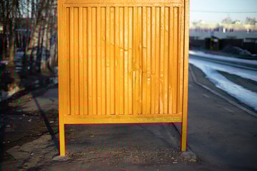 Yellow bus stop. Steel structure by road. photo