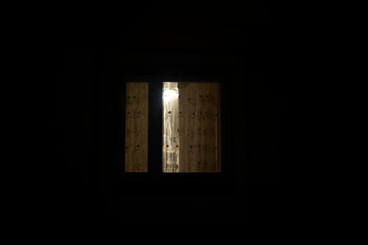 Window is in dark. Curtains on window at night. photo