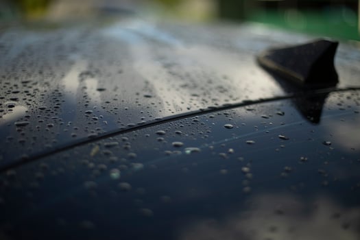 Wet surface of car. Drops on black car. Transport details. photo