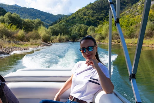 Happy caucasian beautiful woman on the pine forest of a luxury yacht. Pretty sexy fashion model. Montenegro, Lake Skadar. photo