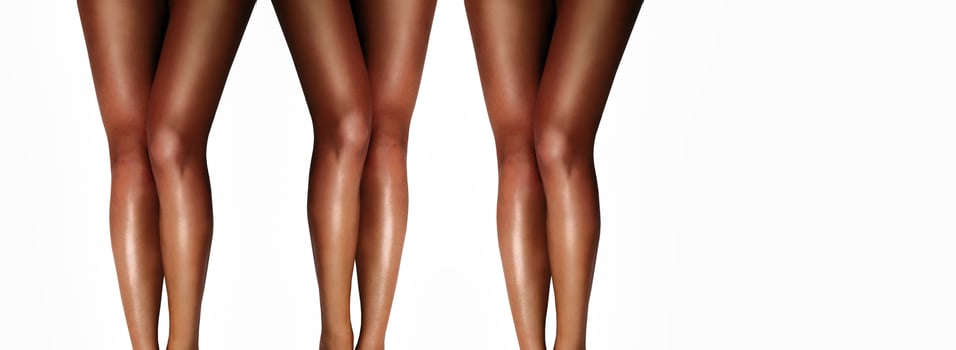 Beautiful smooth woman's legs after laser hair removal on the white background. Treatment, technology concept photo