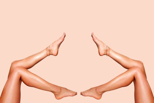 Beautiful smooth woman legs after laser hair removal on the colorful background photo