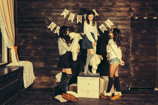 Three charming girls playing with Christmas toys photo