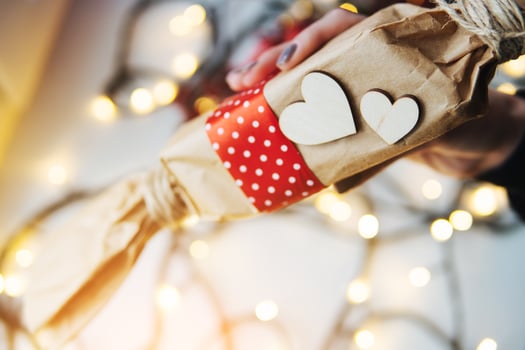 girl holding a Christmas gift in hand photo